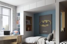 20 a super hero themed room with a Batman poster and an Iron Man mask plus Superman-inspired touches