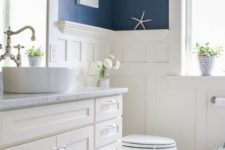 20 white wainscoting matches the furniture and appliances and creates a fresh feel with blue walls