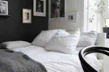 22 a Scandinavian bedroom in black and white, with proper artworks covering the corner