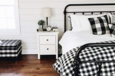 24 buffalo check pillows, a bedspread and a matching upholstered bench for a cozy farmhouse bedroom
