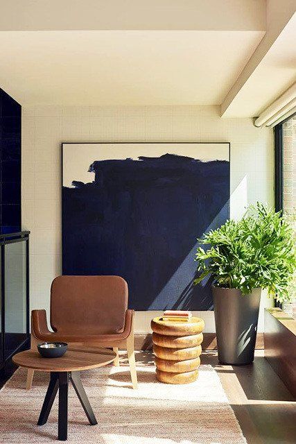 a mid-century modern reading nook with a moody artwork that makes it look special