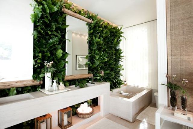 a modern bathroom with a lush living wall and wood to give it a natural feel