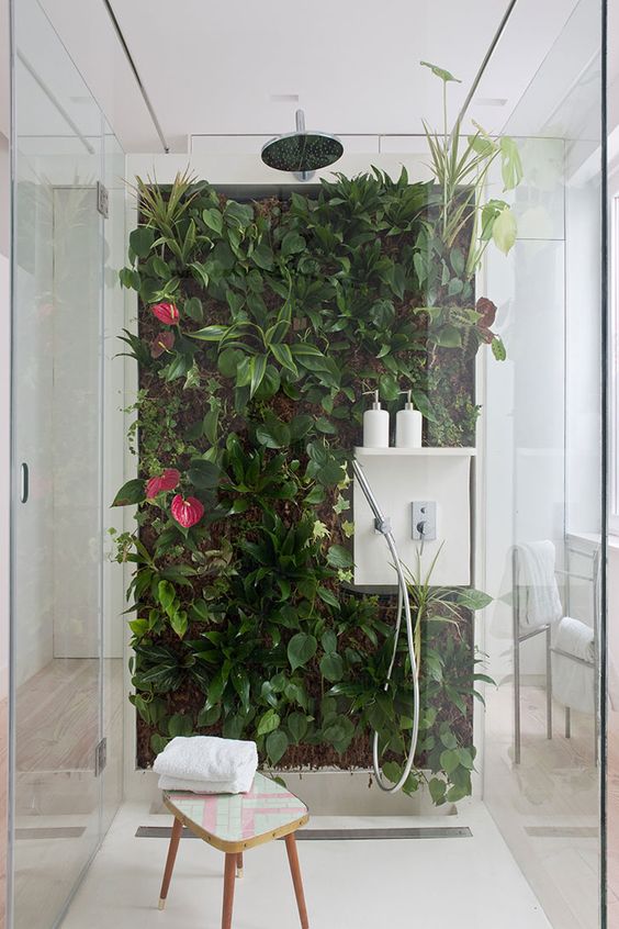 a tropical living wall with flowers right in the shower will make you feel outdoors