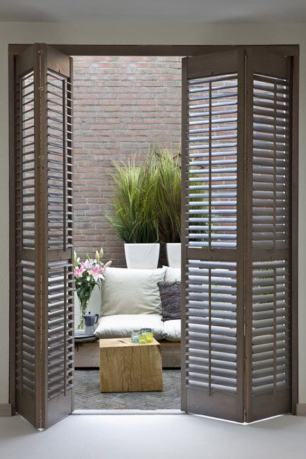 wooden shutter folding doors for terrace access is a chic idea to add farmhouse charm to the space