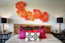 27 colorful geometric sculptures over the bed make a bold accent