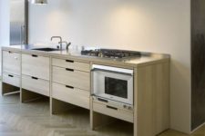 minimalist kitchen cabinets on tall legs make cleaning the floors easier
