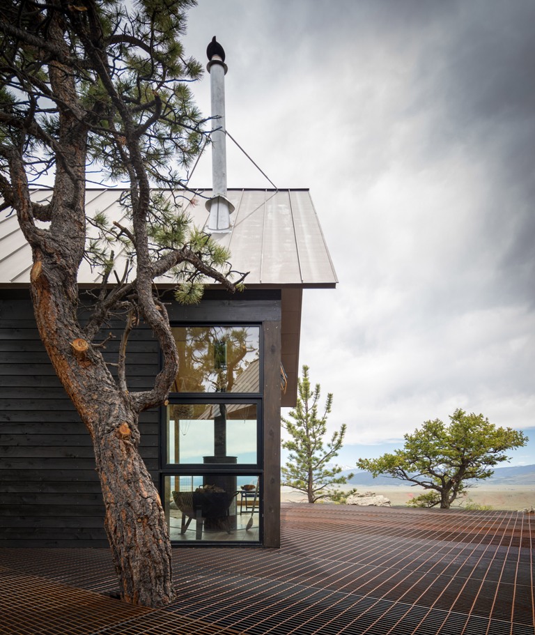 The cabins are united with a large single platform that was cut out to incorporate an old pine tree