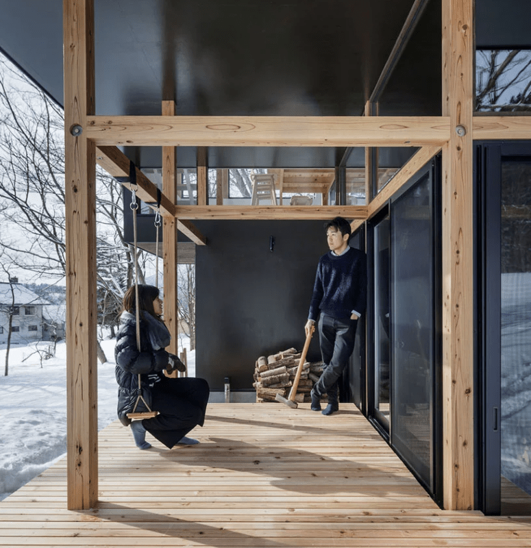 There are outdoor decks with firewood storage and a swing