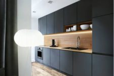 modern black kitchen with lots of natural wood