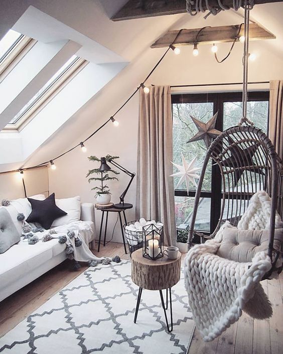 a cozy attic living room decorated in the best hygge traditions