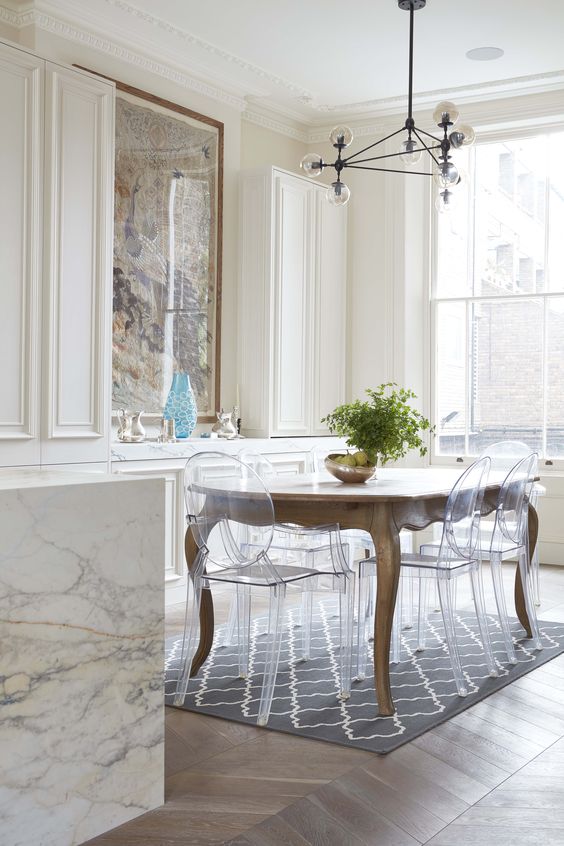 a vintage dining table and clear Ghost acrylic chairs that don't distract attention from the table though make the look wow