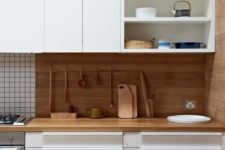 03 a bold contemporary kitchen with white cabinets and touches of light-colored wood for a natural feel