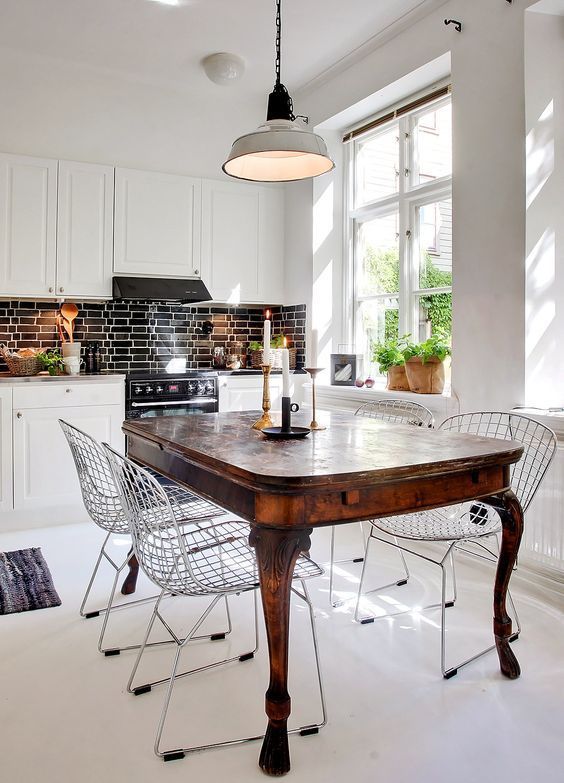 an antique dark stained dining table and metal chairs that create a bold contrast