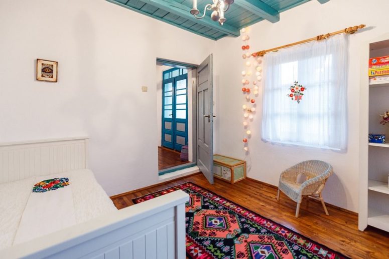 bedroom with string lights The bedroom was done with a turquoise ceiling, some cute string lights and a traditional wooden plank bed