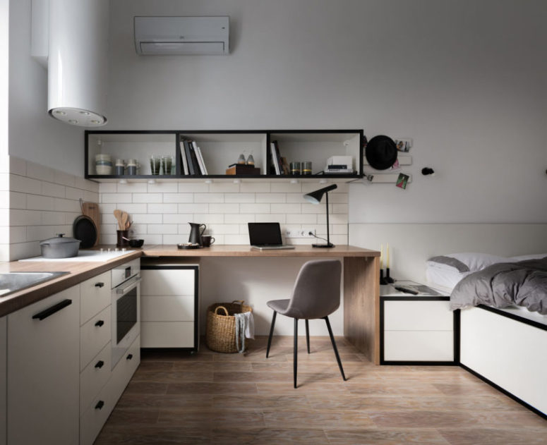 The furniture is modern and simple, there's a built-in cooker, a modern hood with lights and much storage