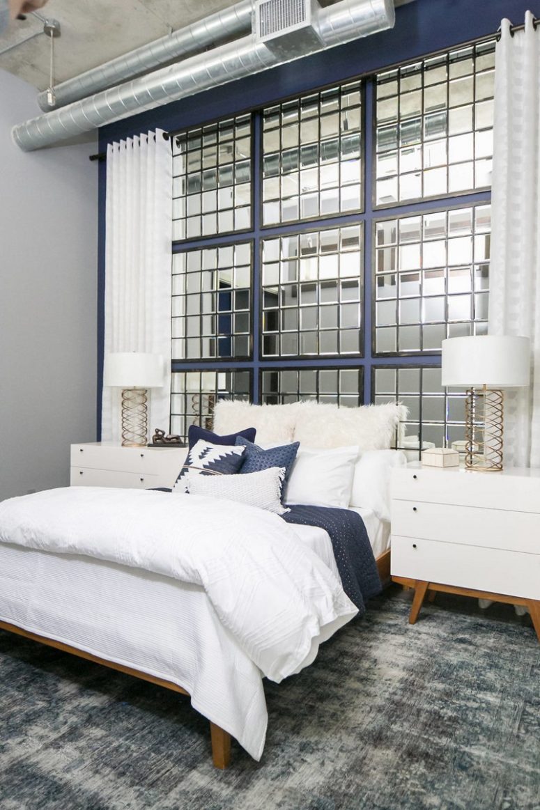 The guest bedroom is more glam, with exposed pipes, a concrete ceiling and a framed mirror headboard wall The guest bedroom is more glam, with exposed pipes, a concrete ceiling and a framed mirror headboard wall