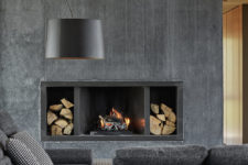 05 Here you may see a concrete built-in fireplace with firewood storage and comfy grey felt furniture