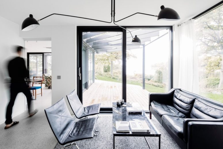 minimalist living room design The living room is done in black and white, with modern and minimalist furniture and much glazing