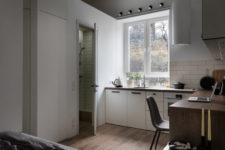 05 There’s a large window and a tiny bathroom space clad with off-white tiles