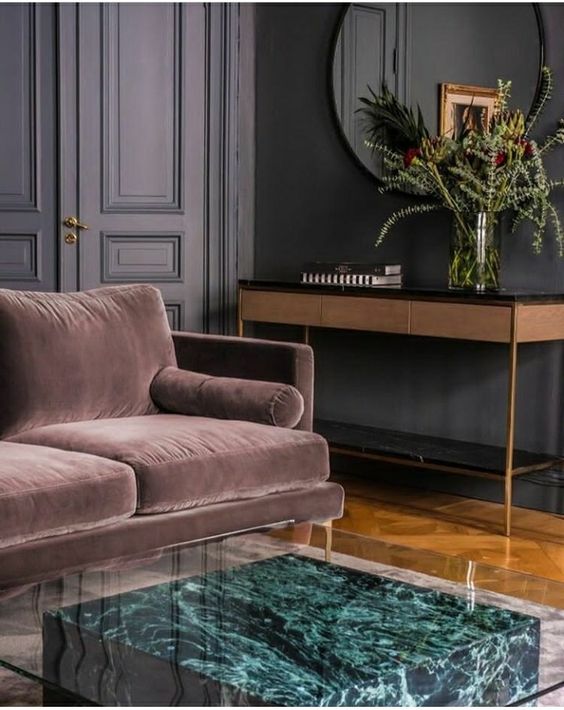 a gorgeous modern side table of a green marble slab and a glass top makes a refined statement