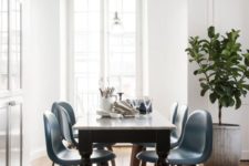 05 a vintage black and white table and mid-century modern blue chairs on curved legs to a bold look