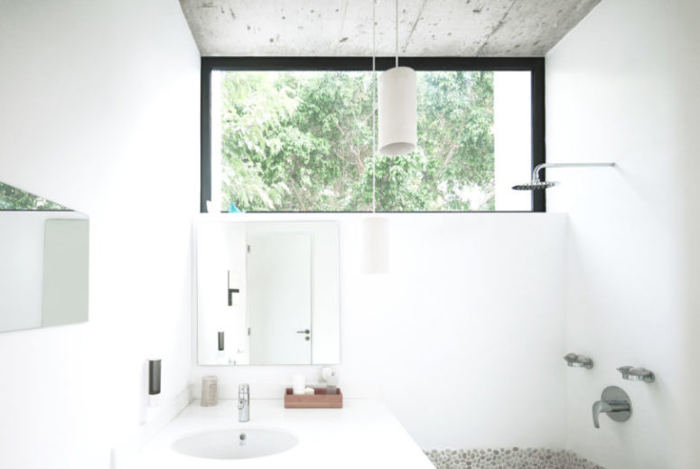 A tiny bathroom has everything necessary, and there's a window to fill it with light and fresh air