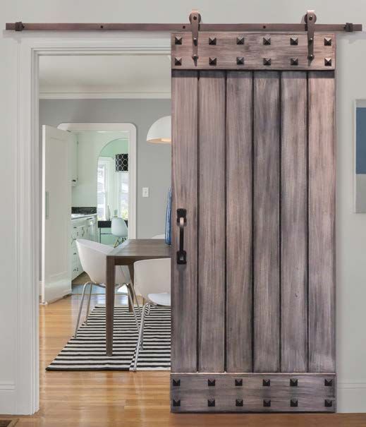 this sliding barn door with exposed hardware and studs makes a bold statement in a modern space