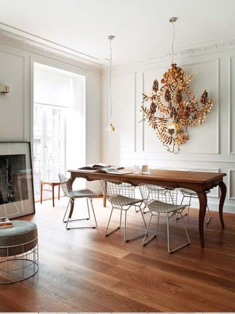 a refined vintage chair and artwork on the wall are calmed down with simple metal chairs