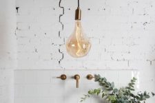 07 a very cool idea of accent lighting is a large pendant lamp with a brass accent and matching fixtures