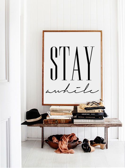 a wooden bench on metal legs, a vintage bowl, books and an oversized sign for a stylish free-spirited space
