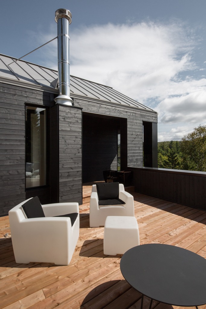 There's also a terrace on top with some modern black and white furniture and amazing views