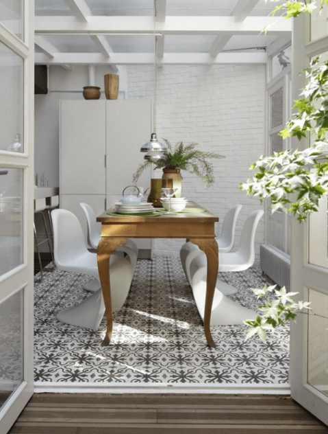 a vintage dining table is spruced up with sculptural white modern chairs