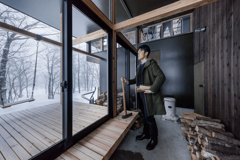 The entryway features a part of the deck and more firewood storage