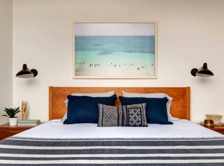 The master bedroom features a wooden bed, some nightstands and sconces and a gorgeous artwork from personal owners' photos The master bedroom features a wooden bed, some nightstands and sconces and a gorgeous artwork from personal owners' photos