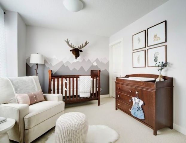 a mountain statement wall, a faux moose head add interest to a neutral and peaceful space