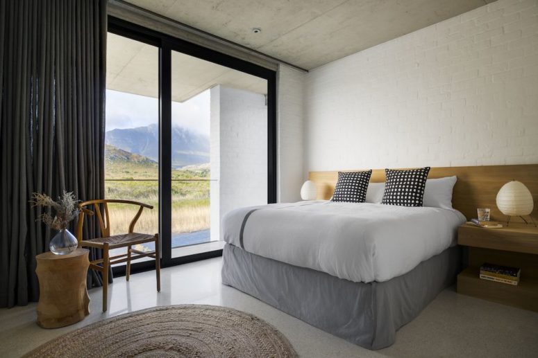 bedroom with a raised platform bed The master bedroom features a tall platform bed and floating nightstands plus gorgeous views