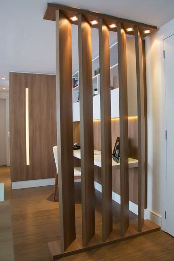 a light up wooden plank screen and a wooden wall from the second side make a small home office private