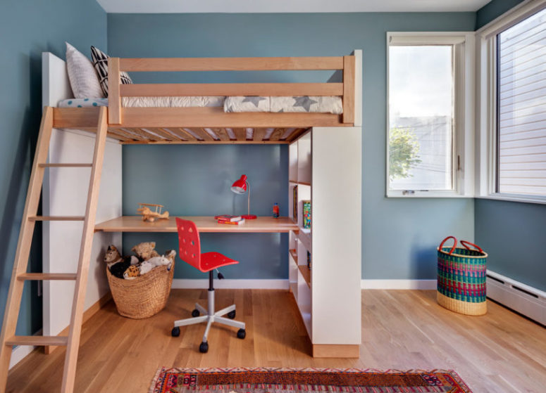 The kids' room is done in a creative way with a wooden bed up placed on shelving units and with a desk down The kids' room is done in a creative way with a wooden bed up placed on shelving units and with a desk down