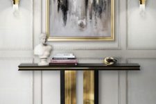 13 a refined black and gold console plus a matching grey, black and white artwork in a gilded frame