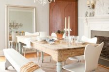 14 an antique table with whitewashed legs and modern white chairs and a bench for a softer vintage look