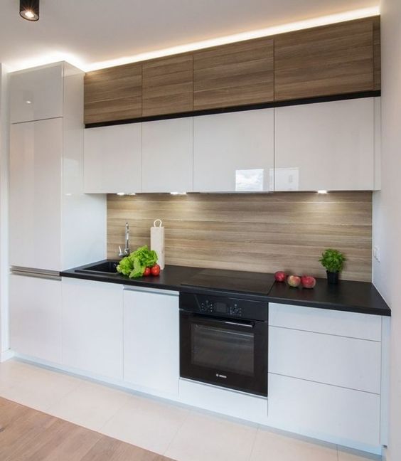 sleek glossy white cabinets plus a light-colored wood backsplash and matching upper cabinets
