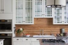 15 traditional white cabinets are warmed up with a light-colored wood backsplash