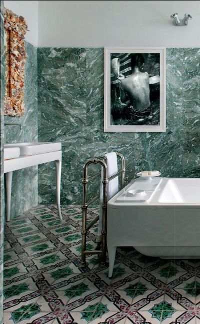 green marble tiles on the walls and mosaic tiles on the floor for a bold eclectic look