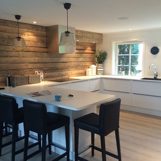 a modern Scandinavian kitchen with lower cabinets and a cool wooden plank wall for a natural feel