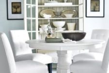 17 a white vintage round table and modern chairs with white upholstery for a refined and chic space