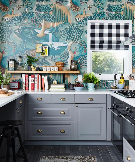 the whole kitchen done with the same colorful wallpaper that makes a bold statement and look
