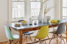 18 a vintage rustic table plus modern colorful chairs and a faux bird cage with colorful faux birds