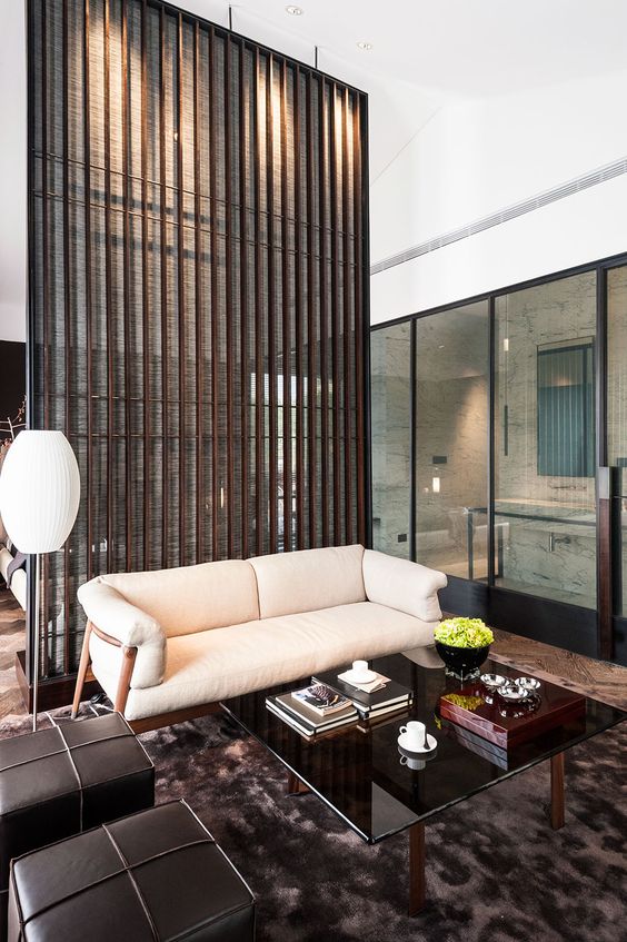 wood plank and light fabric space divider separates the living room and the bedroom gently and with style