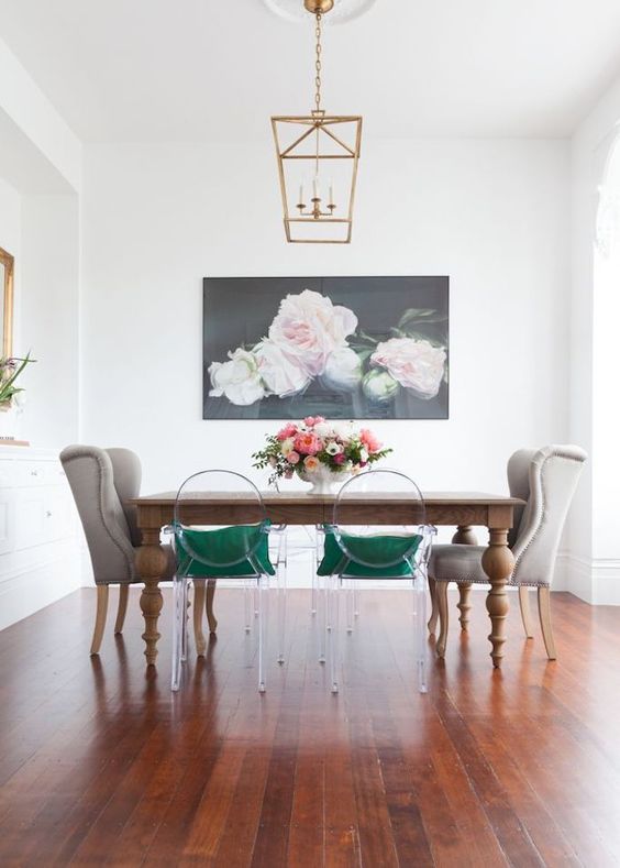 a vintage wooden table and clear acrylic chairs plus grey wingback ones for a bold look