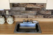 19 cream sleek cabinets, a light-colored wood countertop and a backsplash of reclaimed wood for a unique look